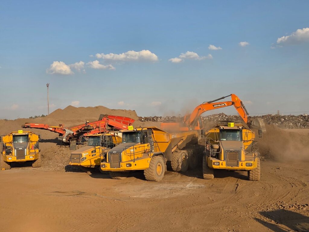 Plant Pro earthmoving fleet with excavator, articulated dump trucks and screening equipment operating on a large construction and mining site in South Africa.